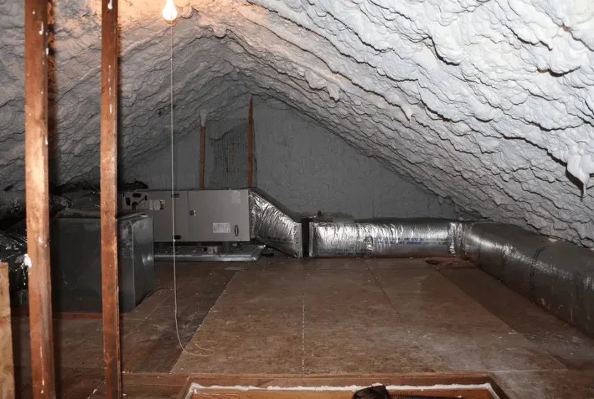 Open-cell spray foam insulation applied to an attic roof deck