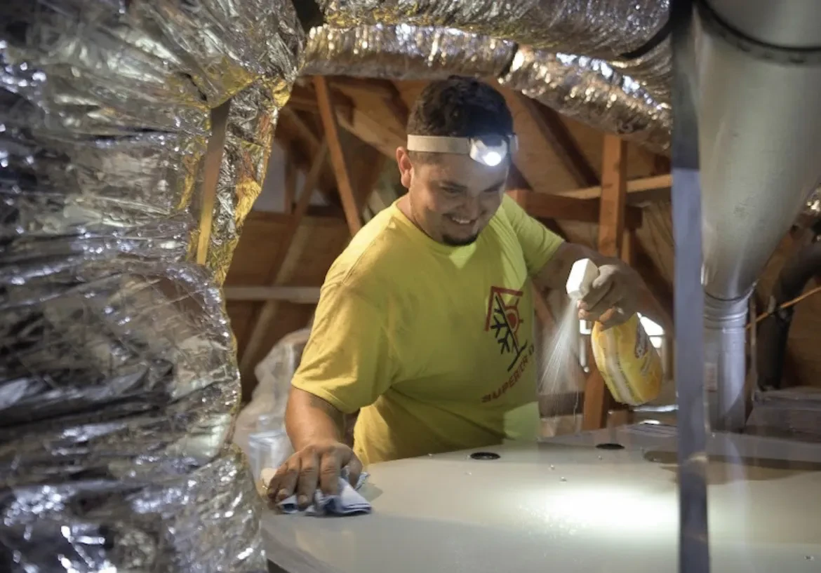 Superior Attic technician preparing equipment