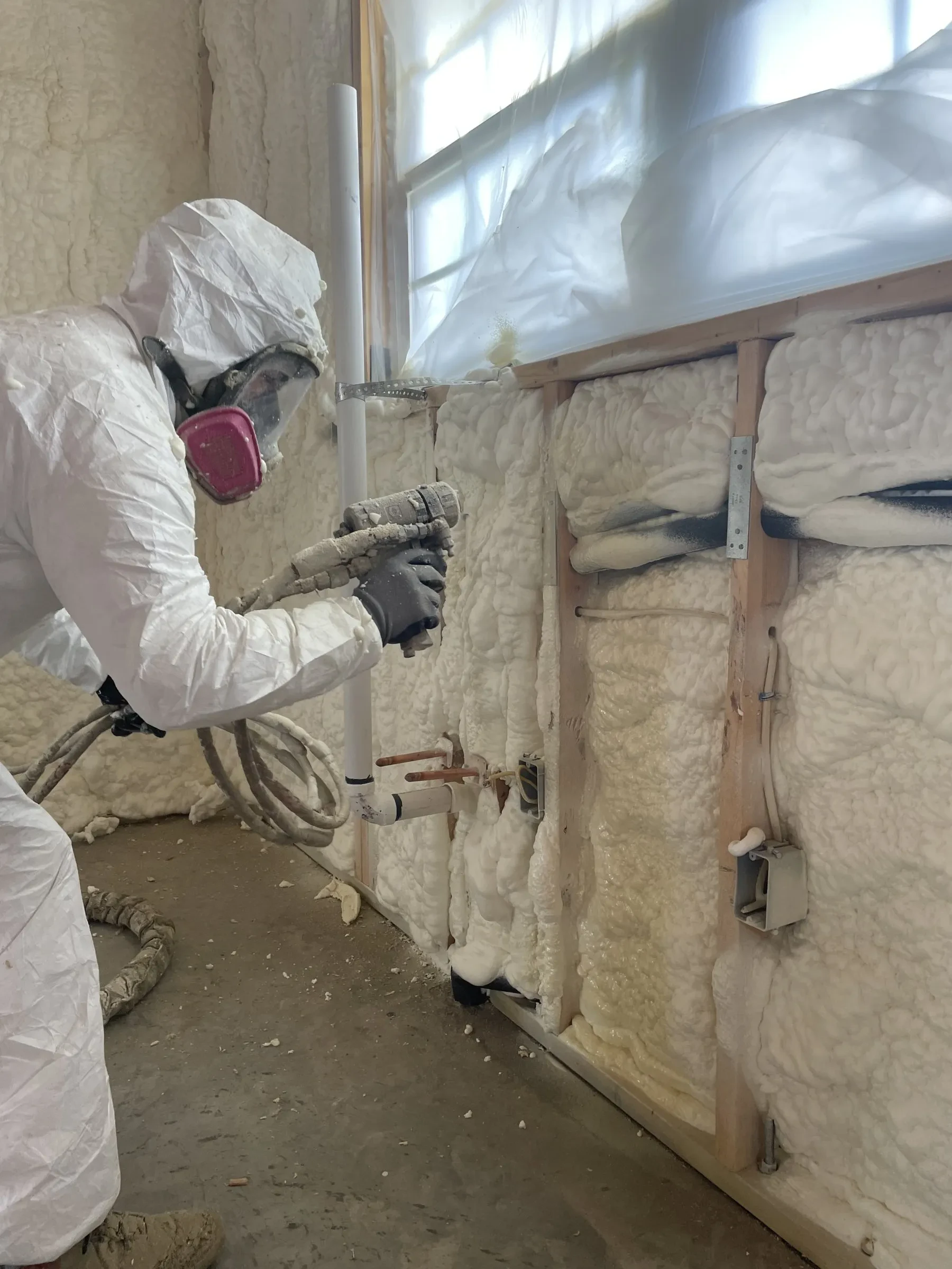 Spray foam applied from the roof peak down to the wall header