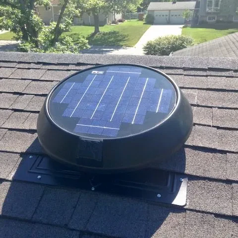 Completed solar attic fan installation on a shingle roof