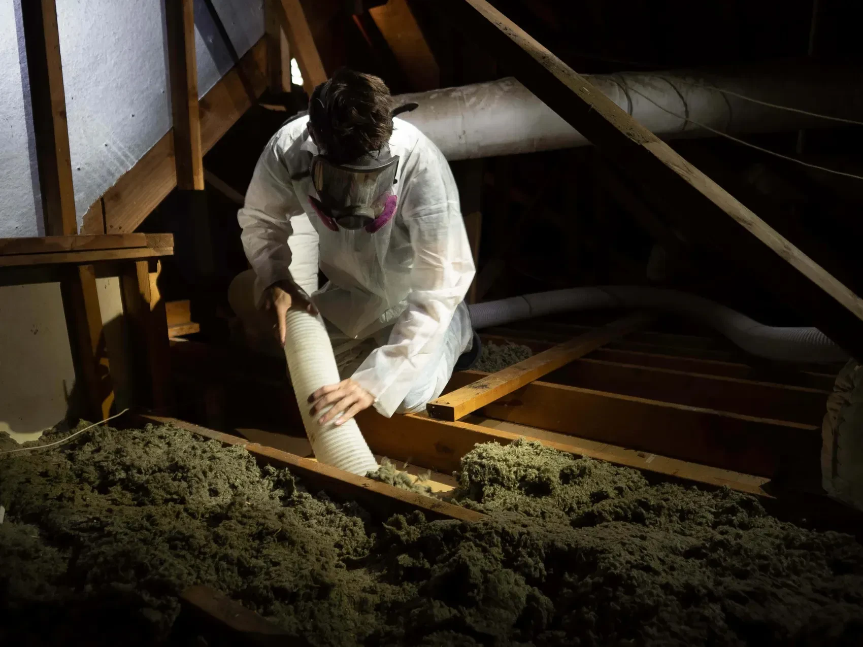 Crew removing old insulation from a building