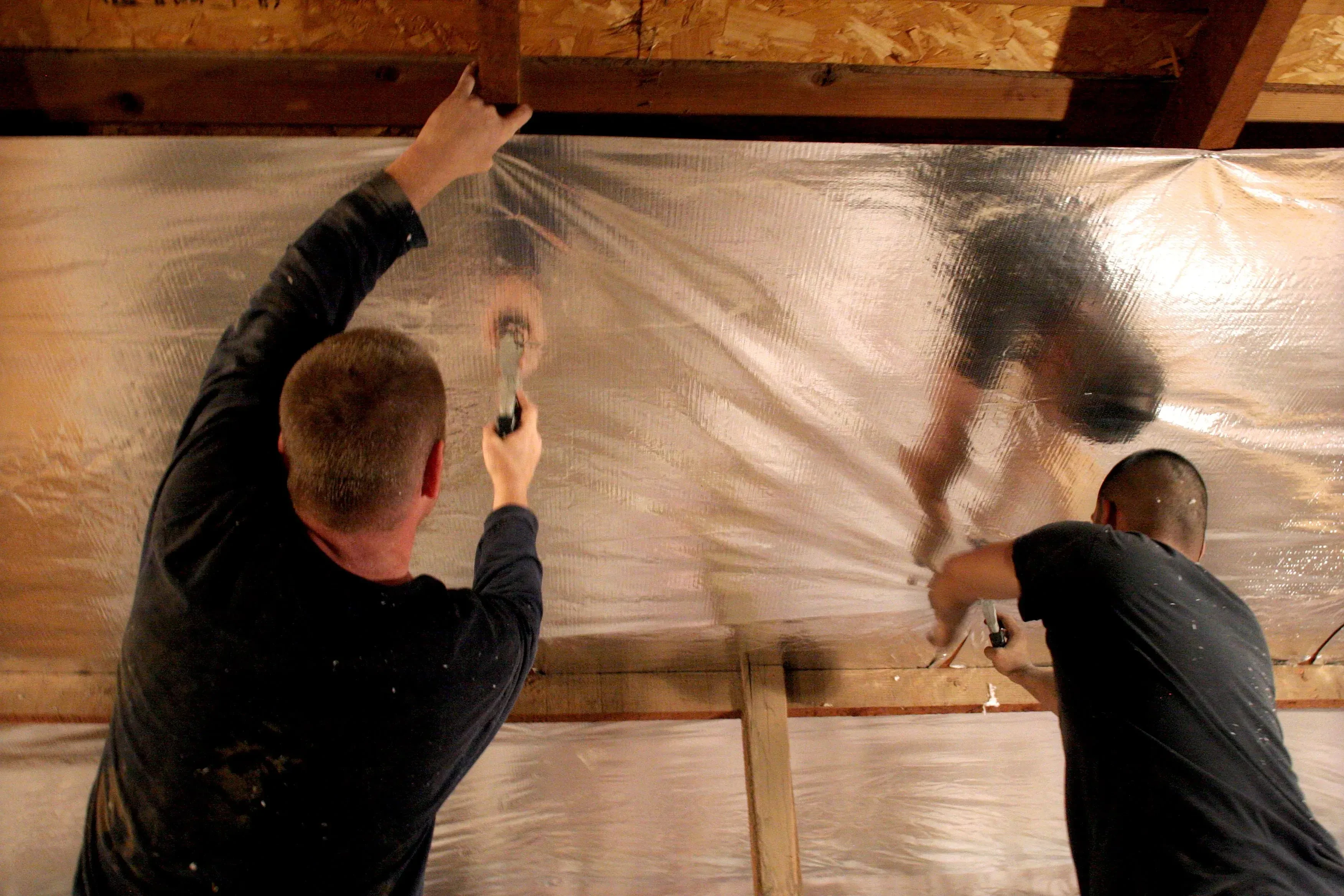 Reflective radiant barrier installed on attic rafters